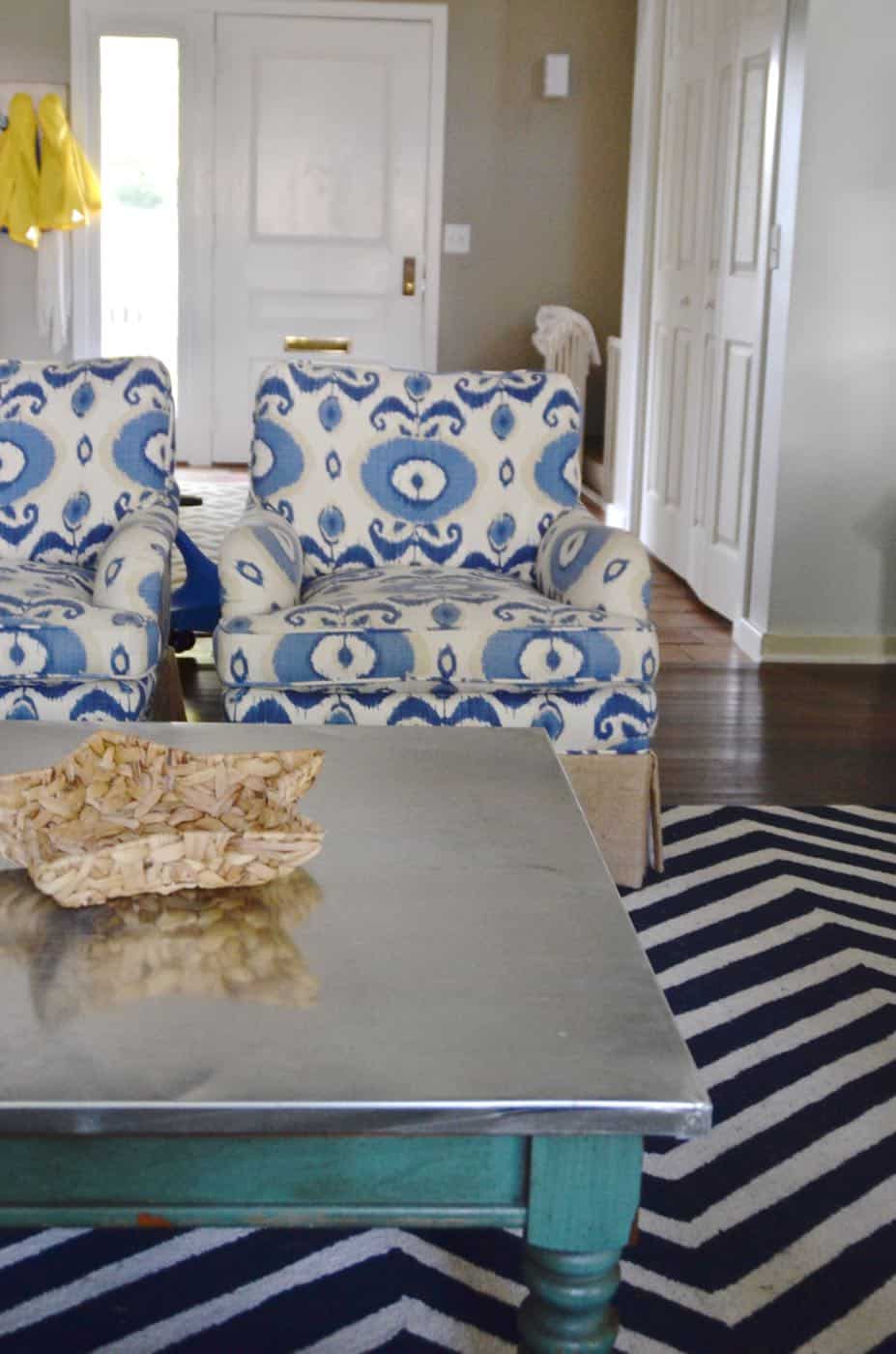 Adding an inexpensive stainless steel looking topper to any coffee table.