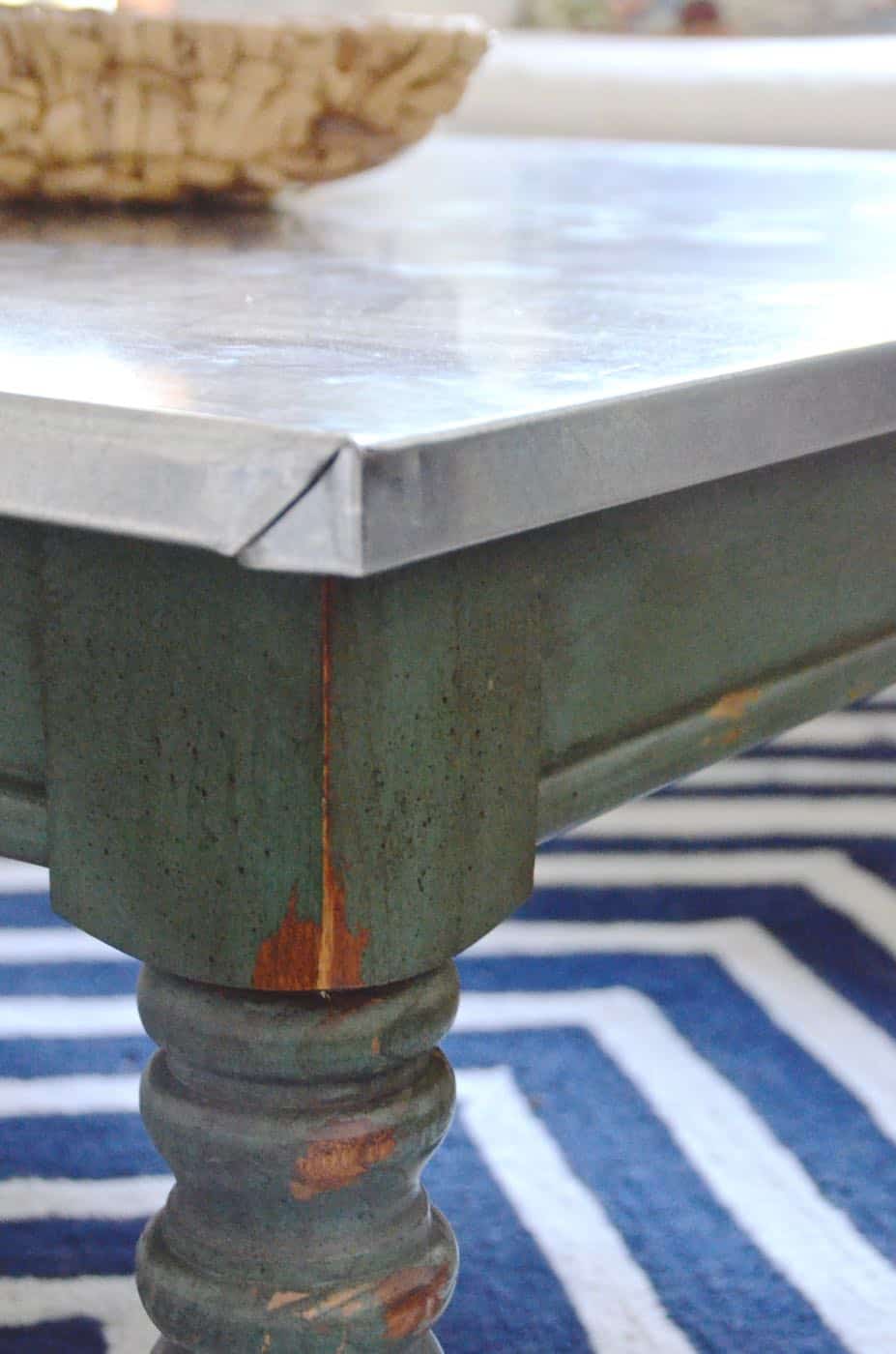 Adding an inexpensive stainless steel looking topper to any coffee table.