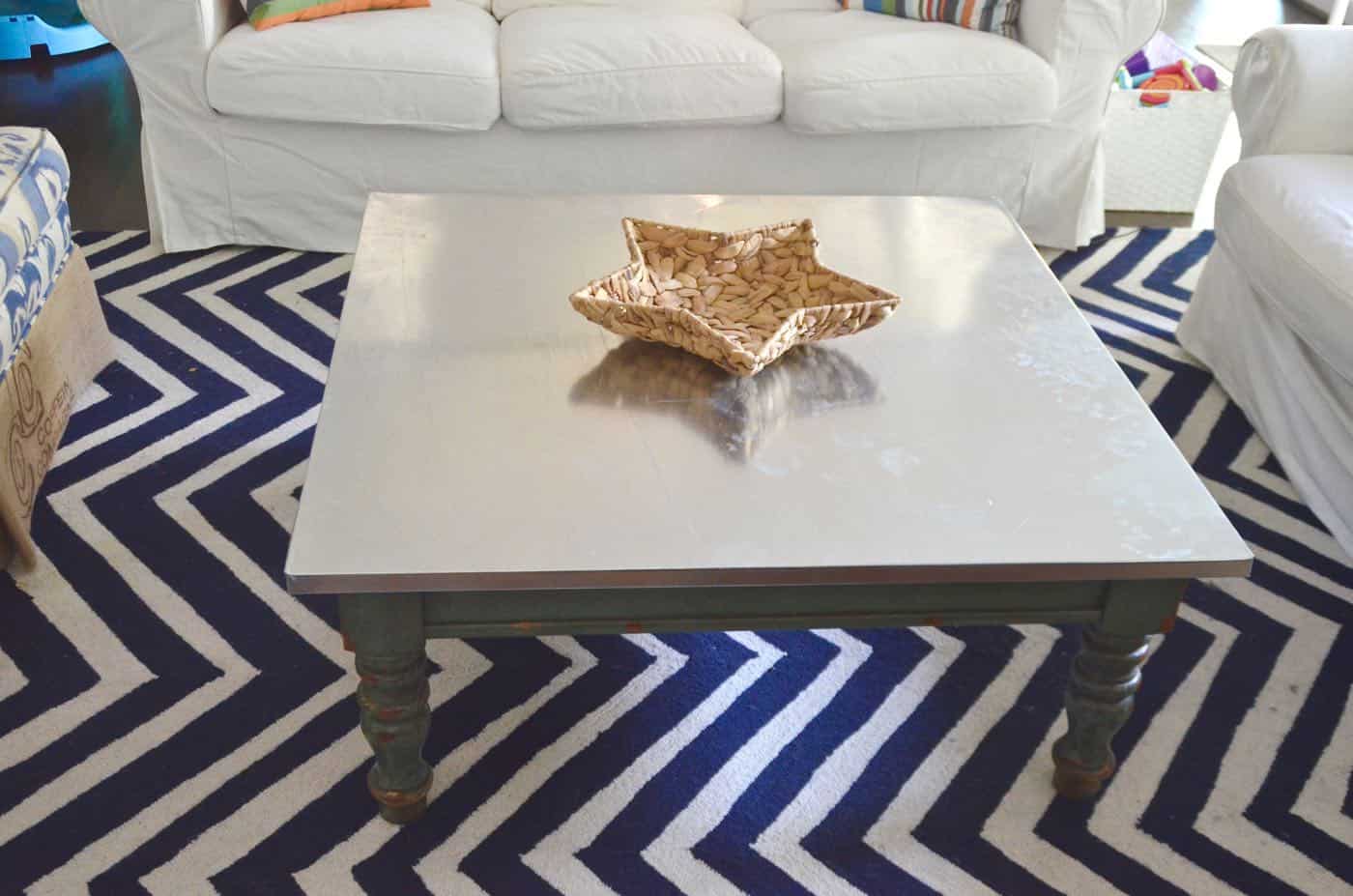Adding an inexpensive stainless steel looking topper to any coffee table.