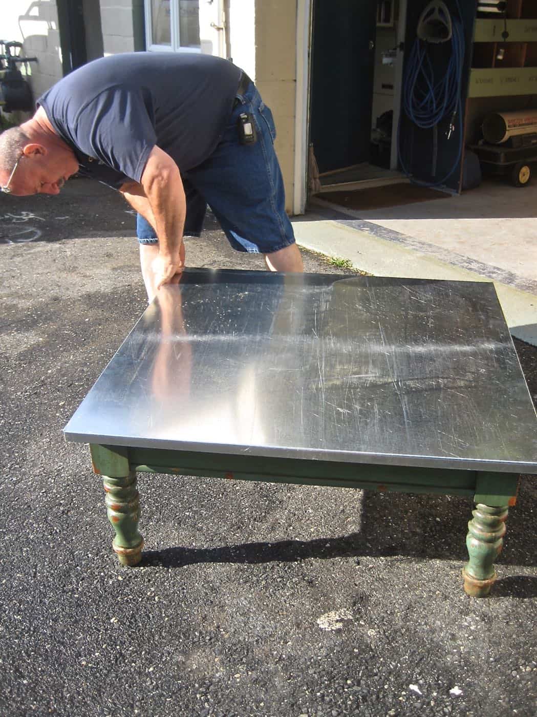 Adding an inexpensive stainless steel looking topper to any coffee table.