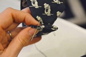 Turning a necktie into a bracelet.