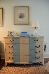 Old bureau gets a fresh look and is now a colorful striped dresser for the master bedroom.