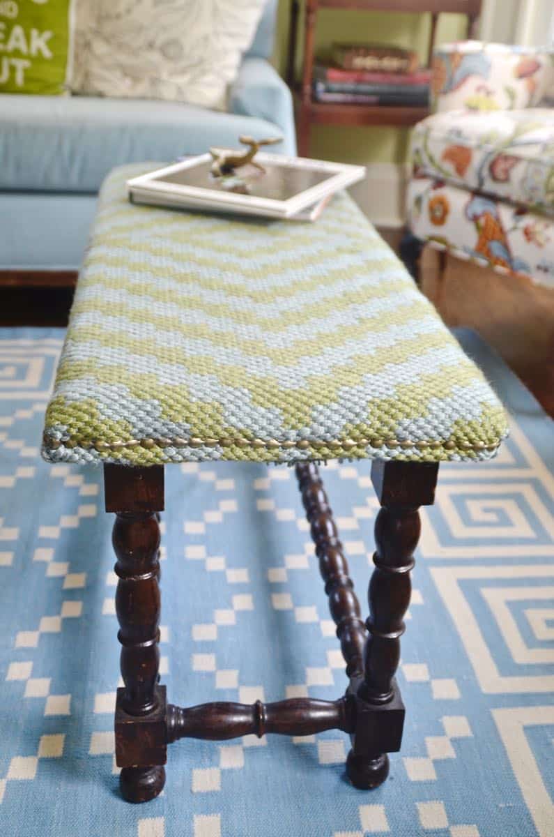 Upholstering a plain bench with a throw rug.