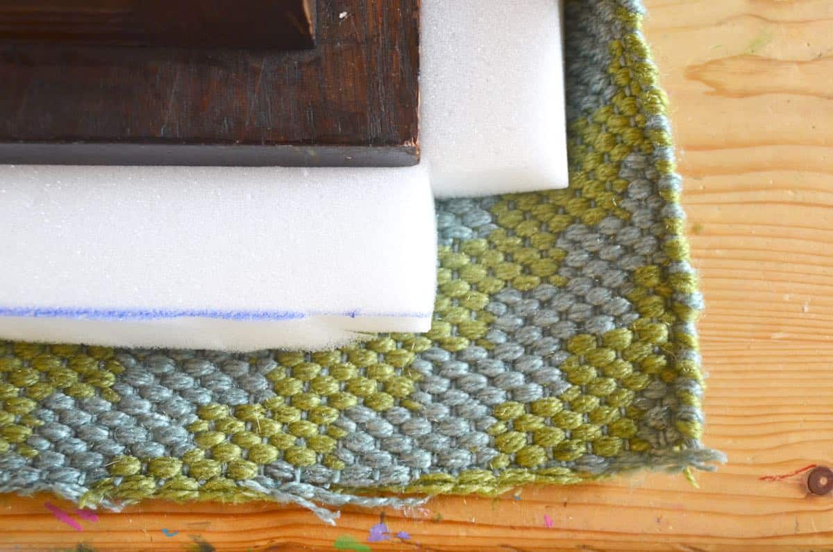 Upholstering a plain bench with a throw rug.