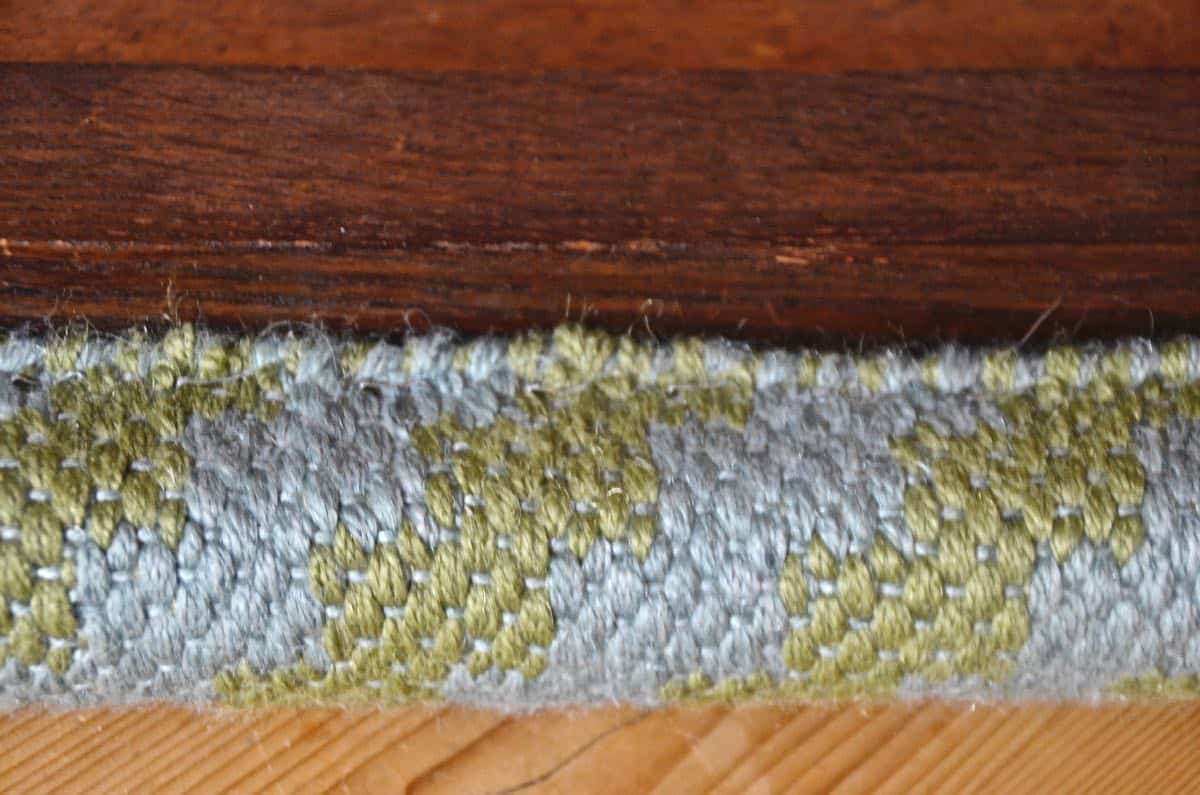 Upholstering a plain bench with a throw rug.