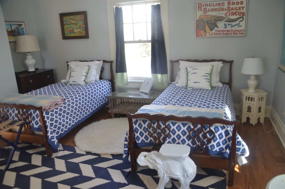 Mixing pattern and flea market treasures in our navy blue guest room.