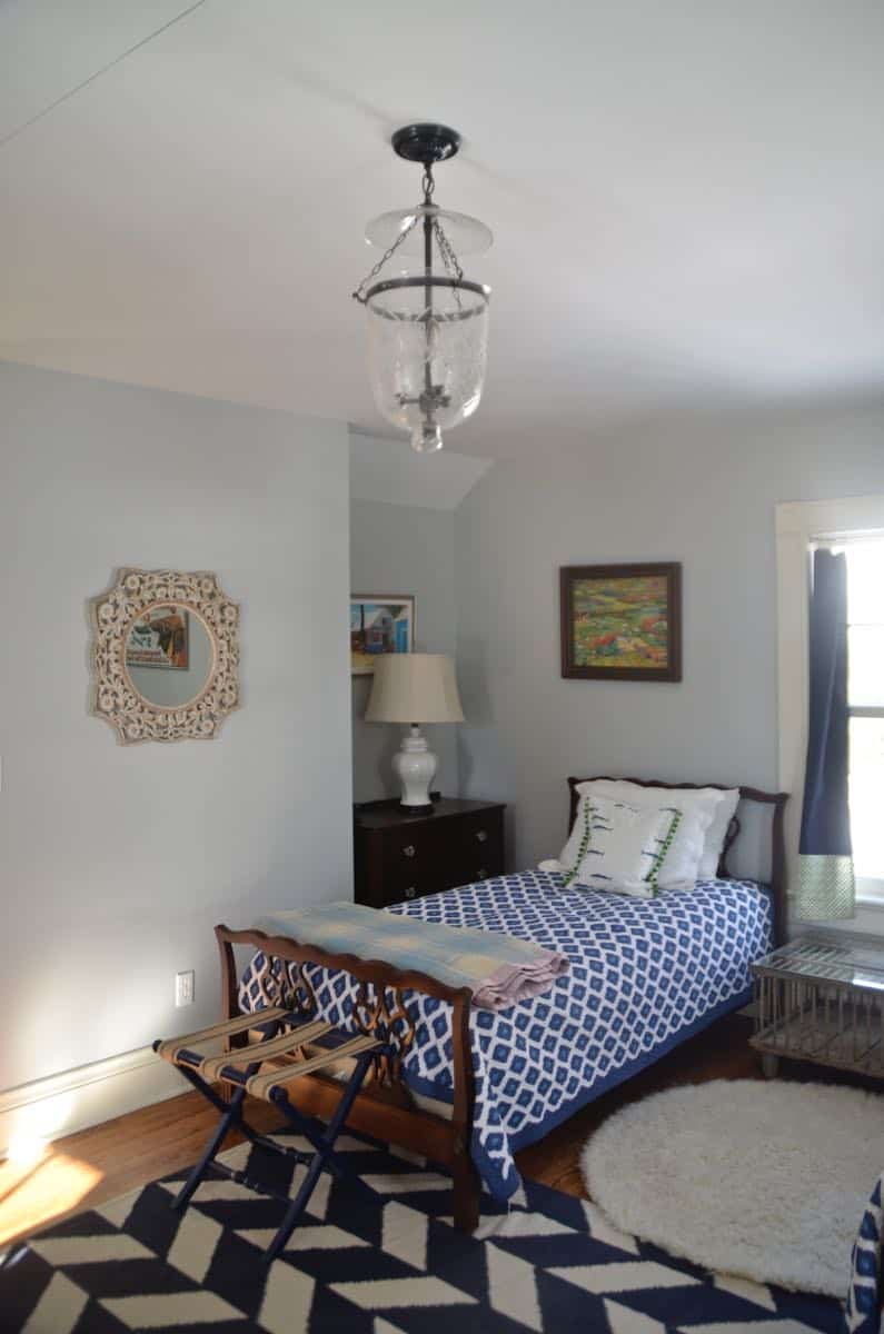 Mixing pattern and flea market treasures in our navy blue guest room.