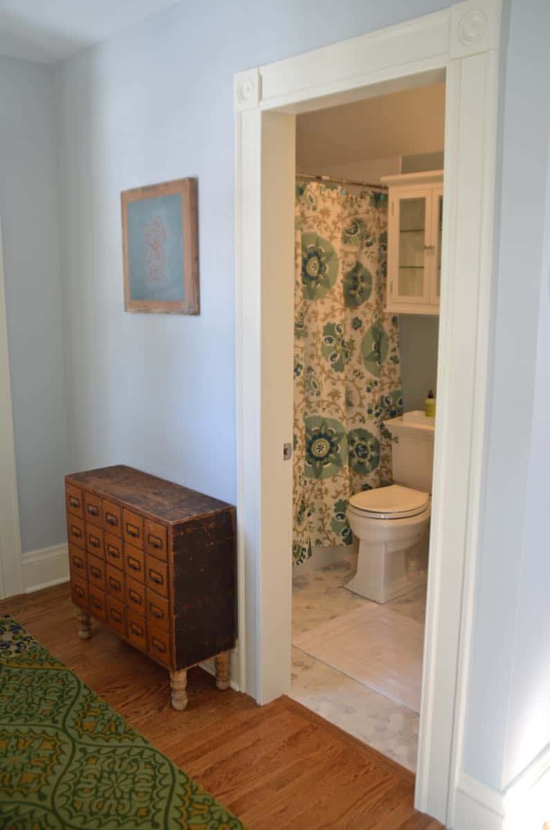 Mixing pattern and flea market treasures in our navy blue guest room.