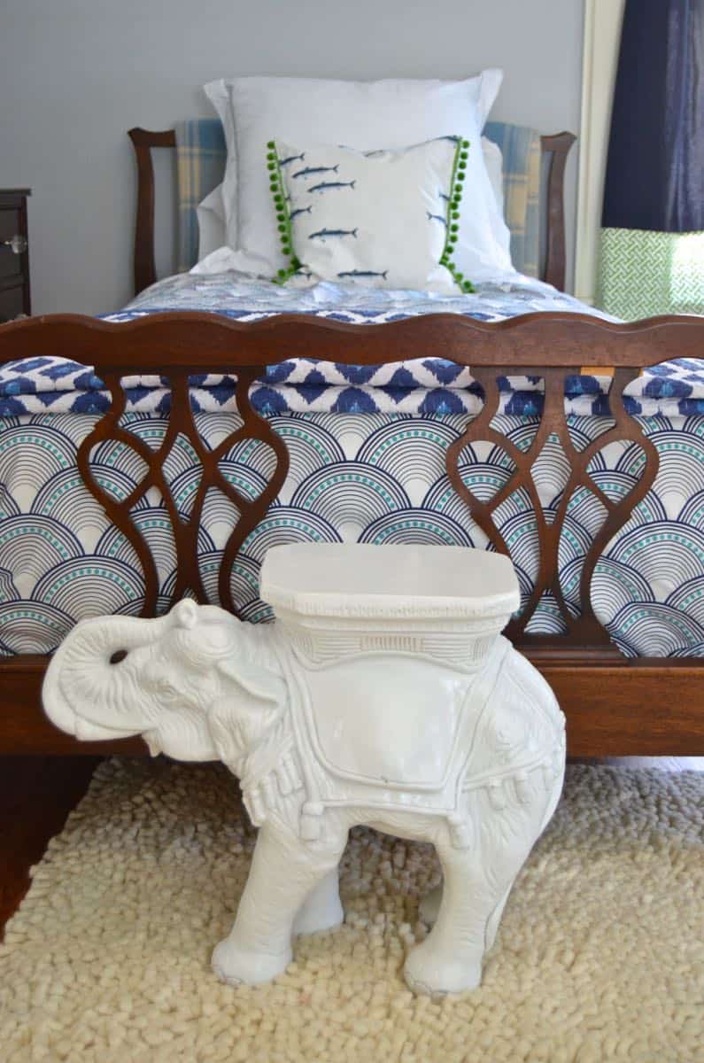 Mixing pattern and flea market treasures in our navy blue guest room.