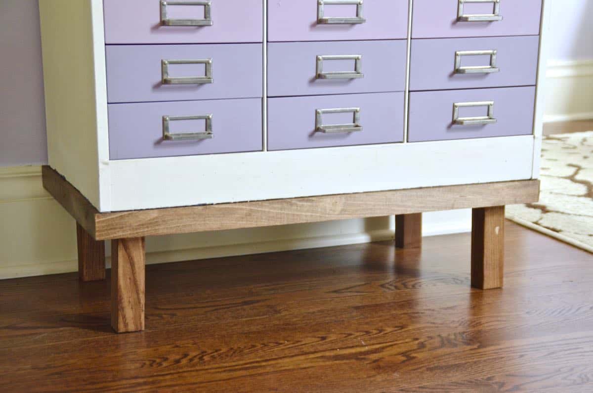 A plain industrial file cabinet is transformed thanks to an ombre paint treatment and a new DIY base.