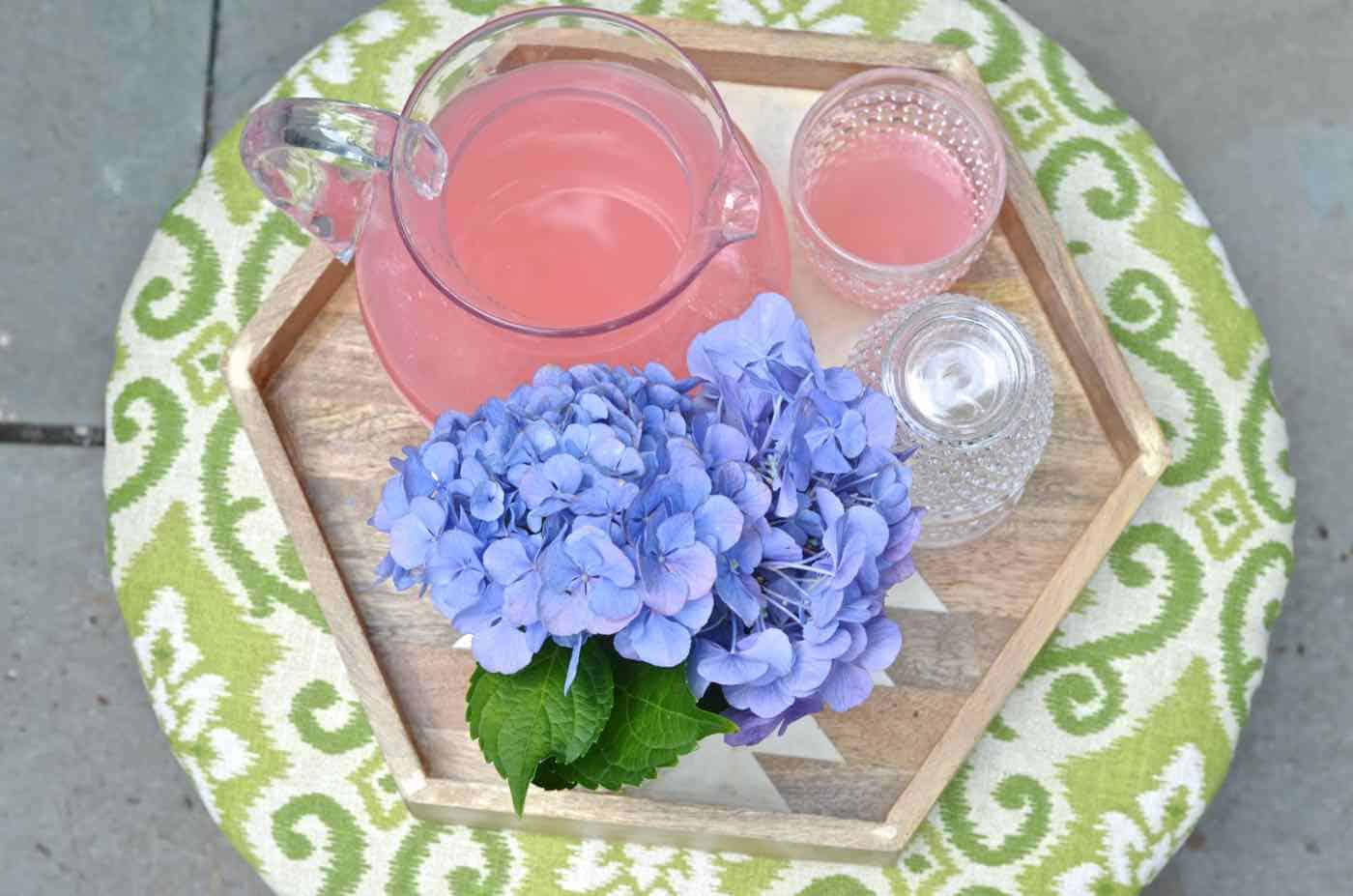 This copper garden hose cover got a makeover as an upholstered storage ottoman for our patio.