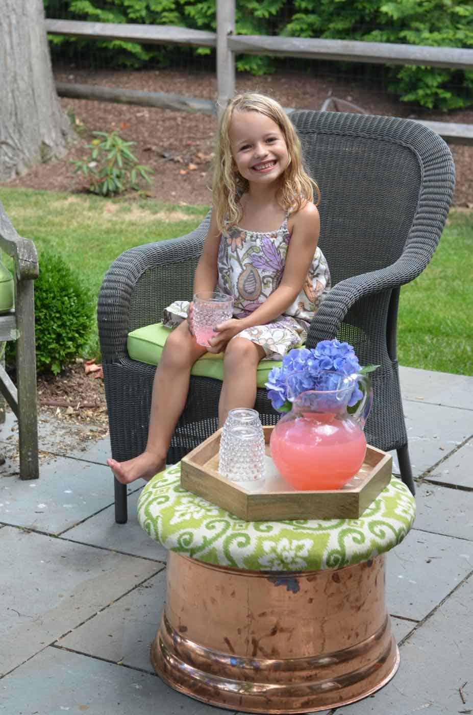 This copper garden hose cover got a makeover as an upholstered storage ottoman for our patio.