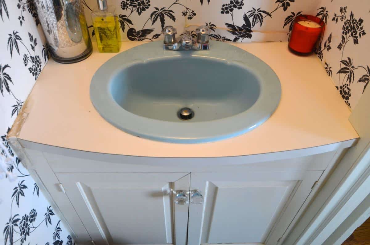 How to transform and old vanity top with concrete for a budget bathroom makeover.