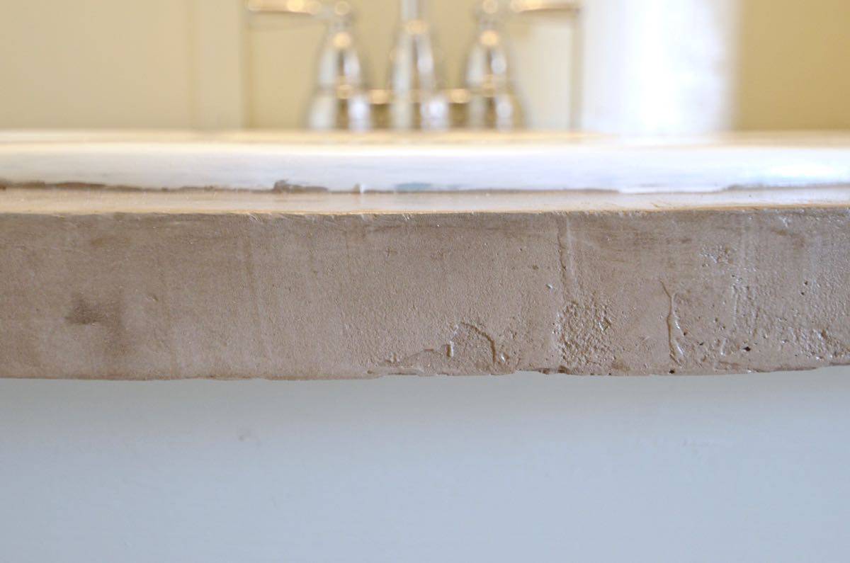 How to transform and old vanity top with concrete for a budget bathroom makeover.