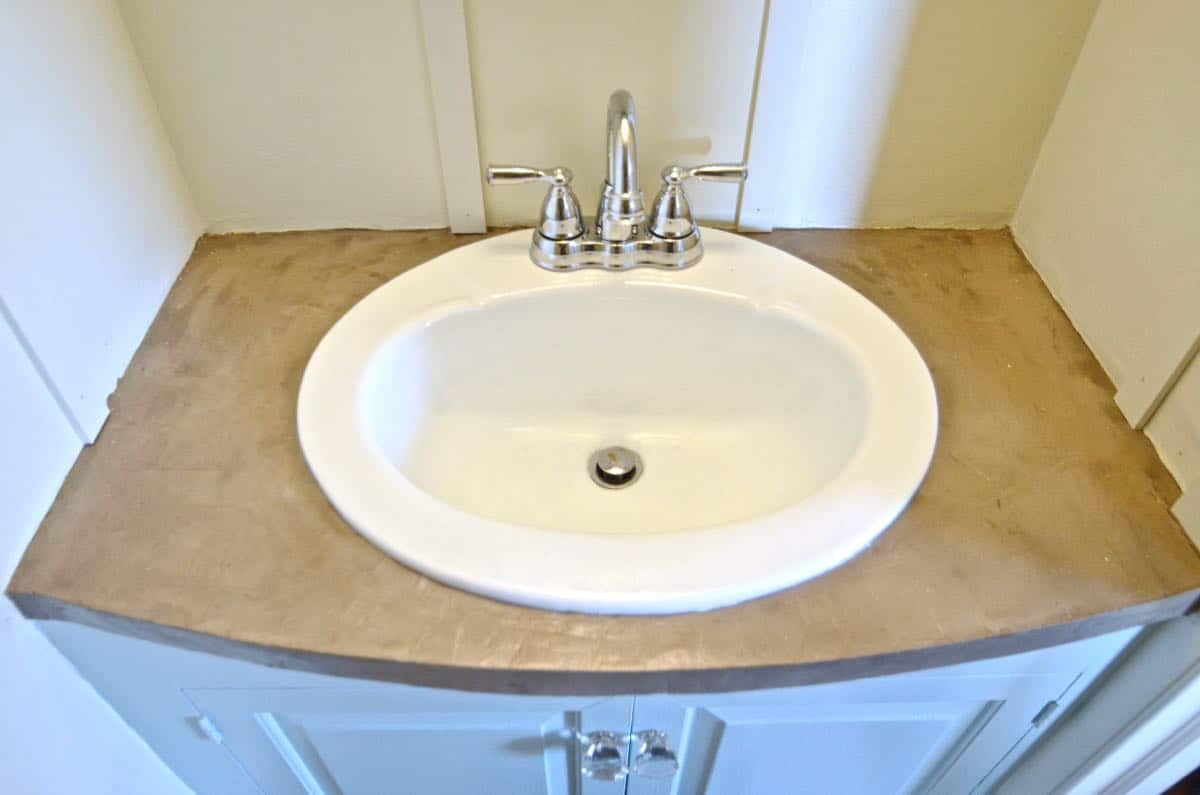 How to transform and old vanity top with concrete for a budget bathroom makeover.