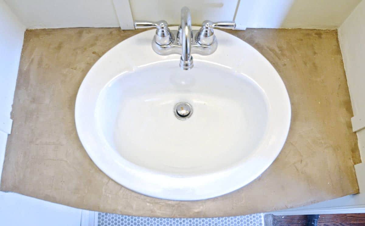 How to transform and old vanity top with concrete for a budget bathroom makeover.