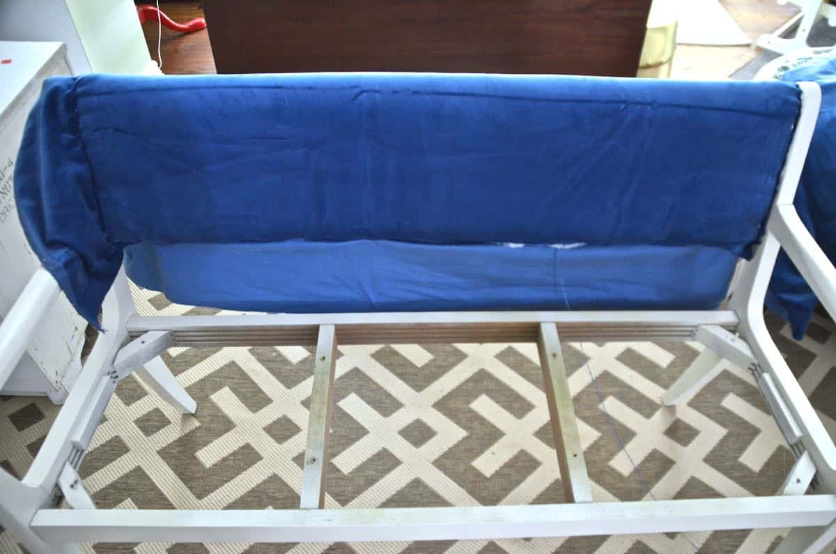 Turn a wooden bench into an upholstered loveseat.