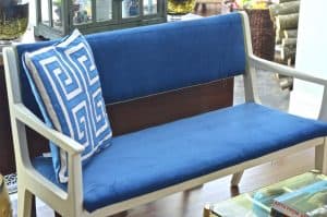 Turn a wooden bench into an upholstered loveseat.