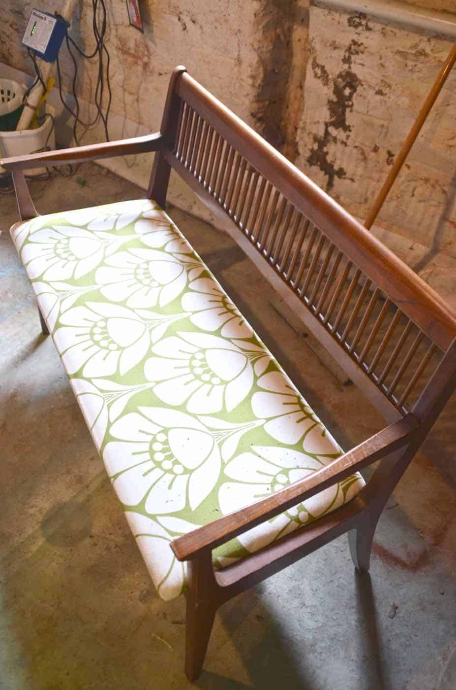 Turn a wooden bench into an upholstered loveseat.