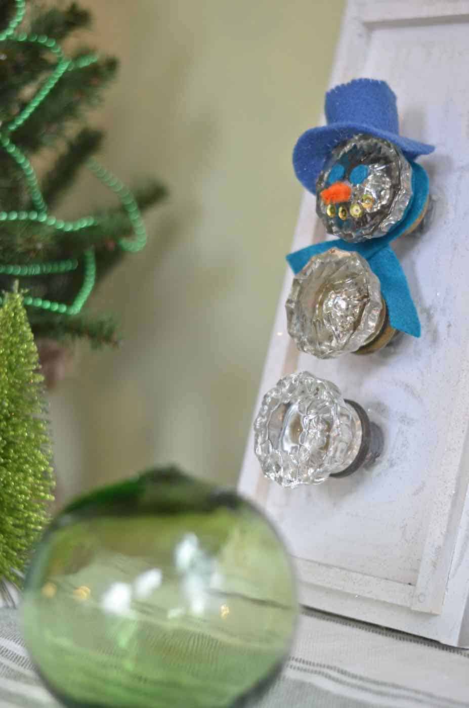 Transform thrifted glass doorknobs into repurposed Christmas snowman.