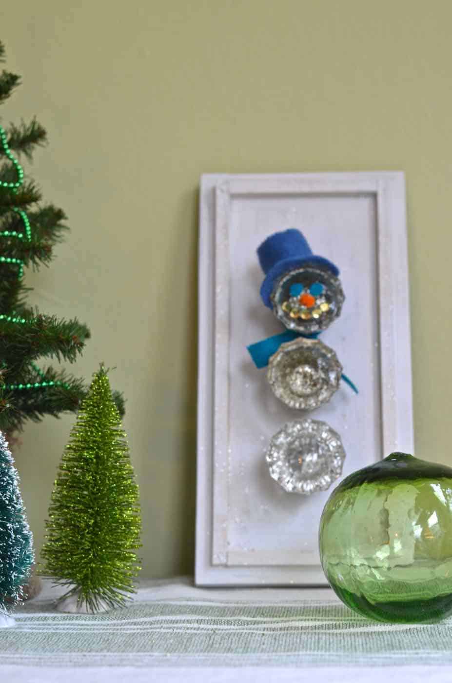 Transform thrifted glass doorknobs into repurposed Christmas snowman.