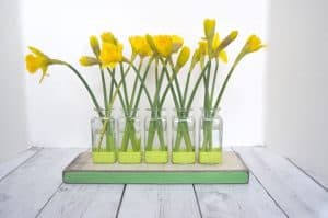 Thrift store glassware is made into this cute bud vase centerpiece.