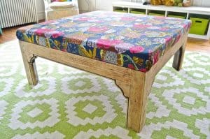 Turn a basic coffee table into an upholstered ottoman.