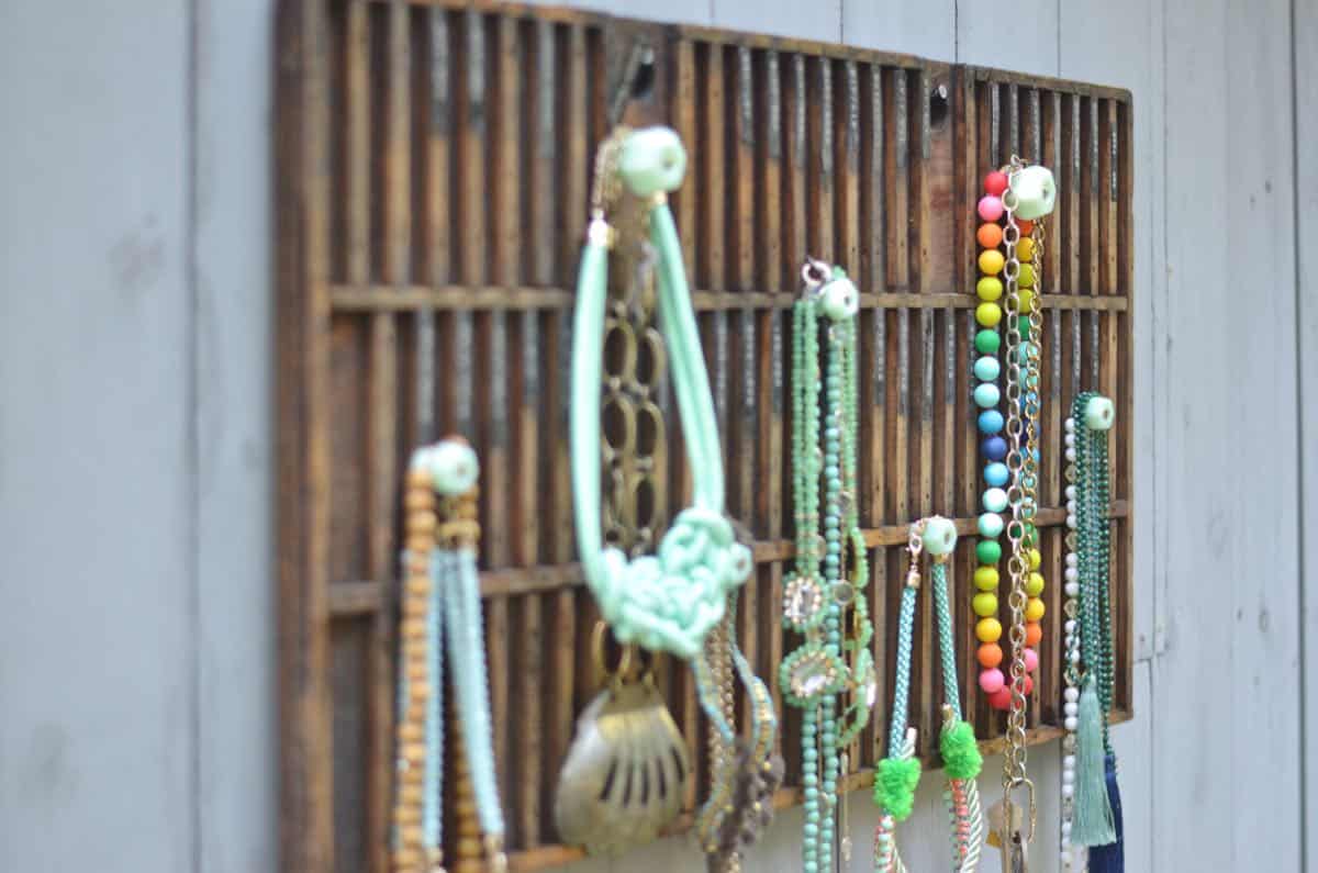 Decorative knobs turned into simple and chic jewelry storage.