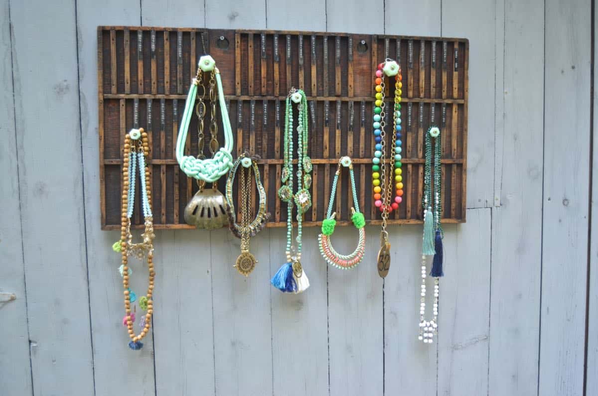 Decorative knobs turned into simple and chic jewelry storage.