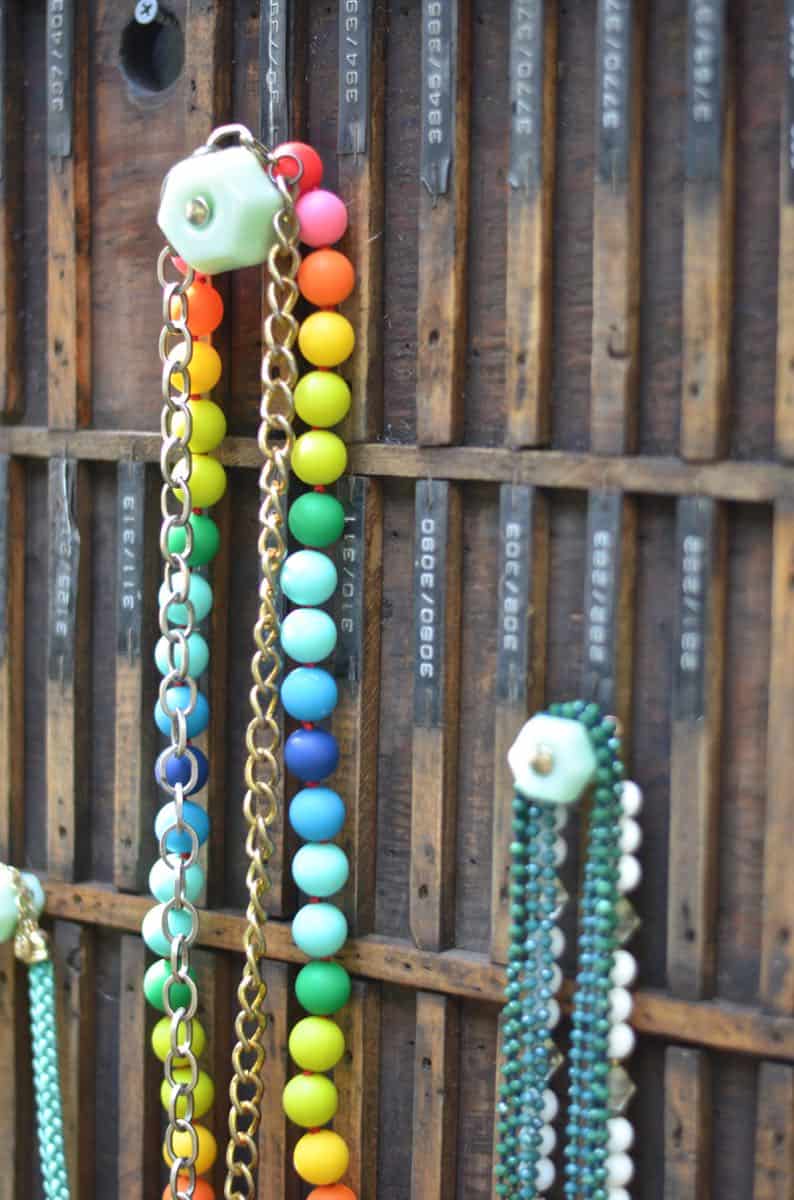 Decorative knobs turned into simple and chic jewelry storage.