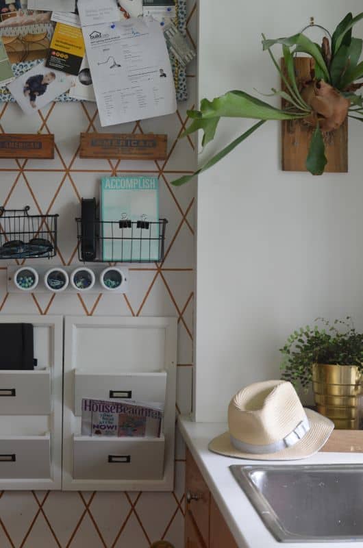 Organize your family with this creative use of one small kitchen wall.