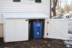 Garbage shed with door open