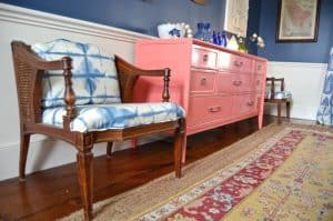 coral sideboard with layered rugs