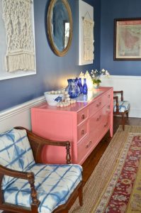coral sideboard with tie dye fabric chairs