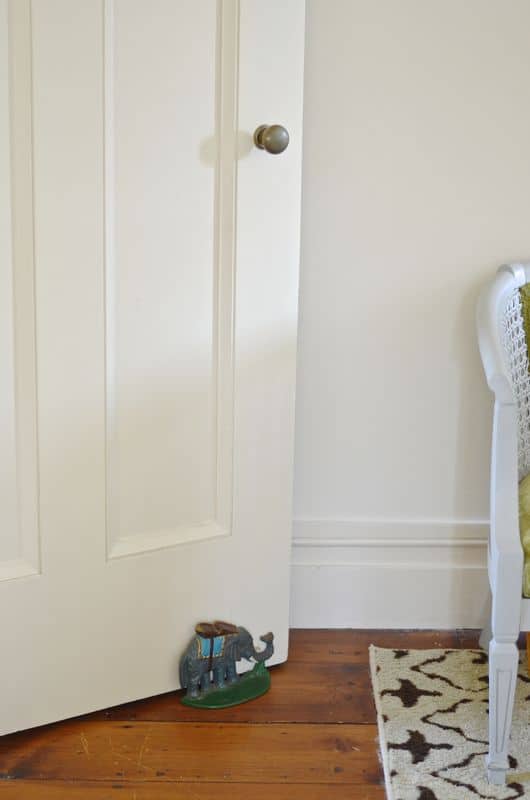 Eclectic foyer pulled together with refurbished furniture and fun fabric and accessories.