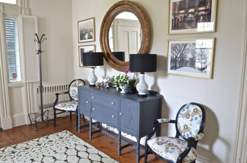 Eclectic foyer pulled together with refurbished furniture and fun fabric and accessories.