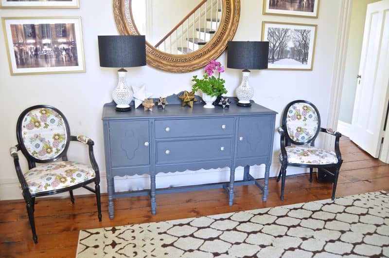 Eclectic foyer pulled together with refurbished furniture and fun fabric and accessories.
