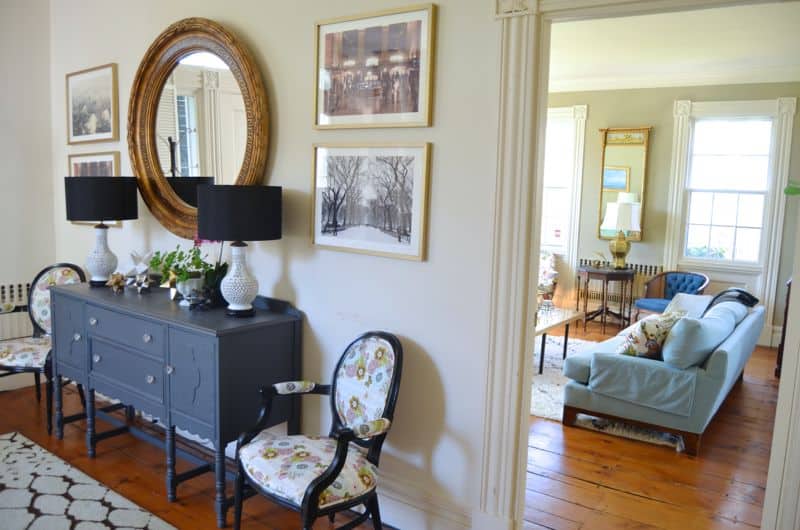 Eclectic foyer pulled together with refurbished furniture and fun fabric and accessories.