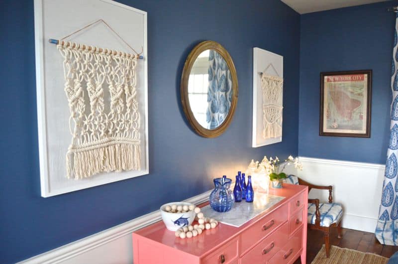 macrame wall hangings over sideboard