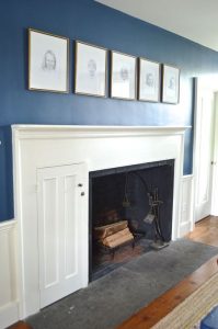 pencil portraits over fireplace
