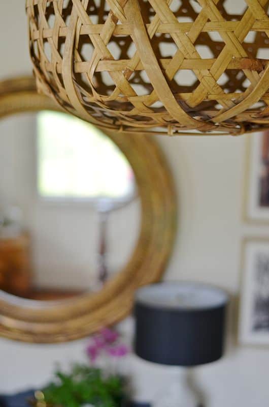 Eclectic foyer pulled together with refurbished furniture and fun fabric and accessories.