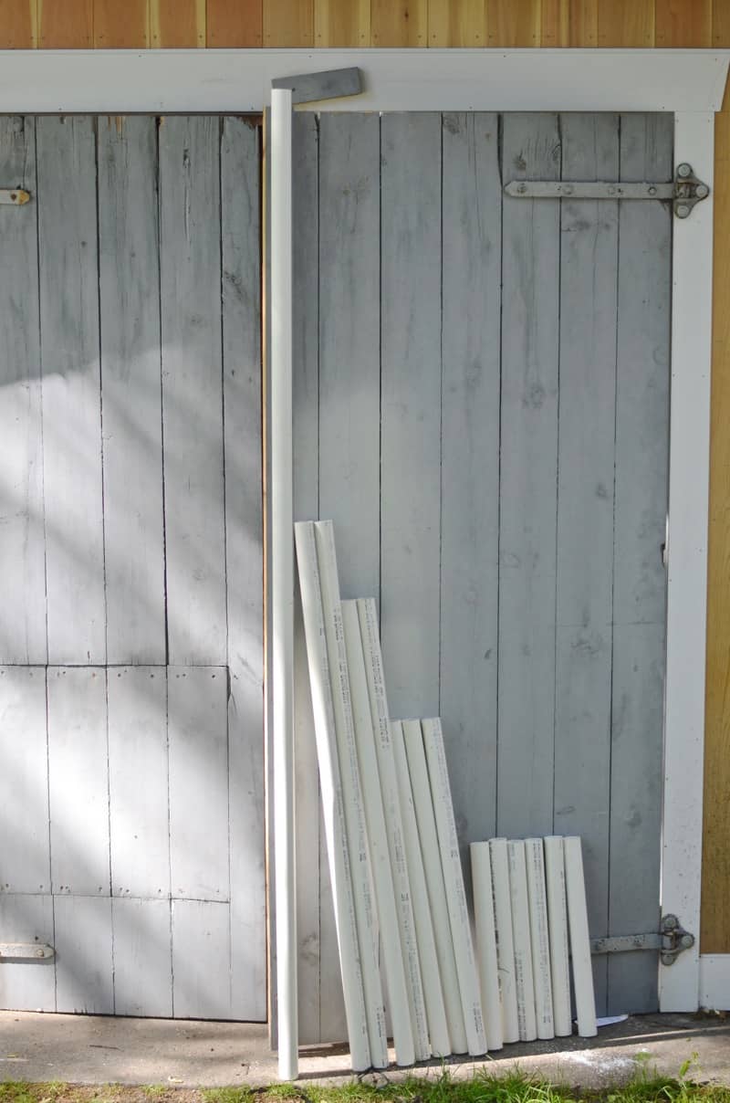 DIY backyard movie screen using PVC pipes and a clearance sheet.