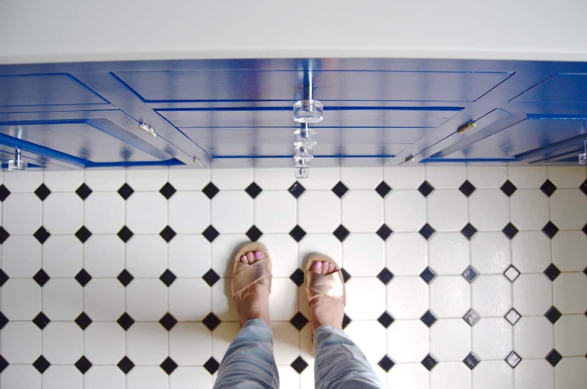 Repainting a basic white vanity with navy blue Satin Enamel paint for an easy bathroom makeover!