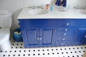 Repainting a basic white vanity with navy blue Satin Enamel paint for an easy bathroom makeover!