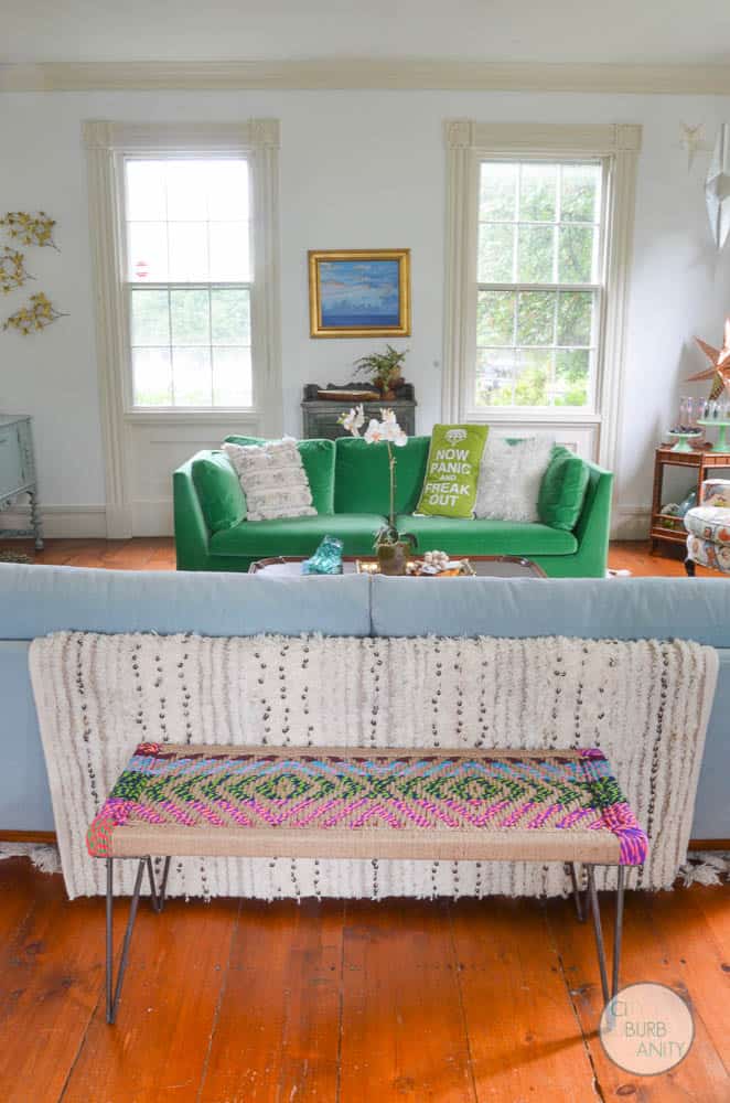 White bright living room with colorful decor and eclectic design.