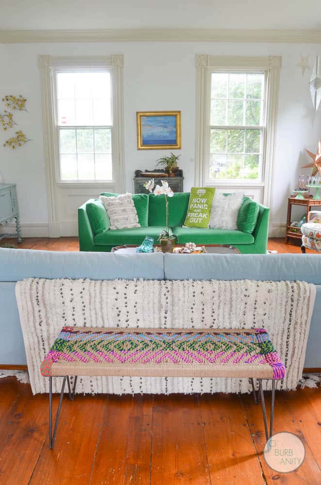 White bright living room with colorful decor and eclectic design.