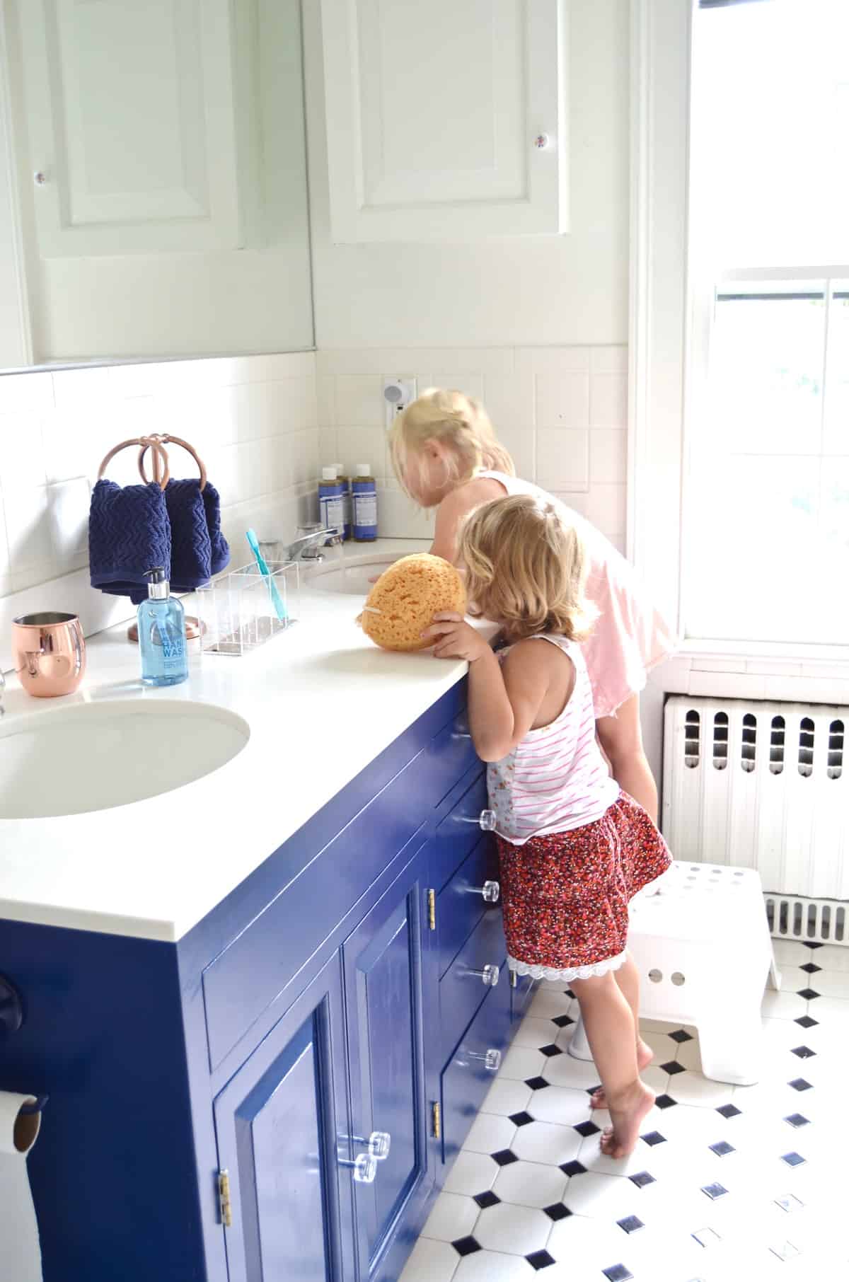 Repainting a basic white vanity with navy blue Satin Enamel paint for an easy bathroom makeover!