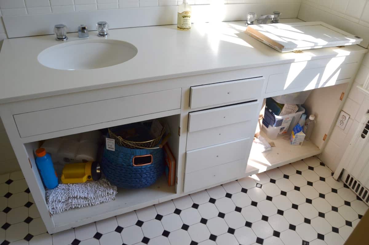 Repainting a basic white vanity with navy blue Satin Enamel paint for an easy bathroom makeover!