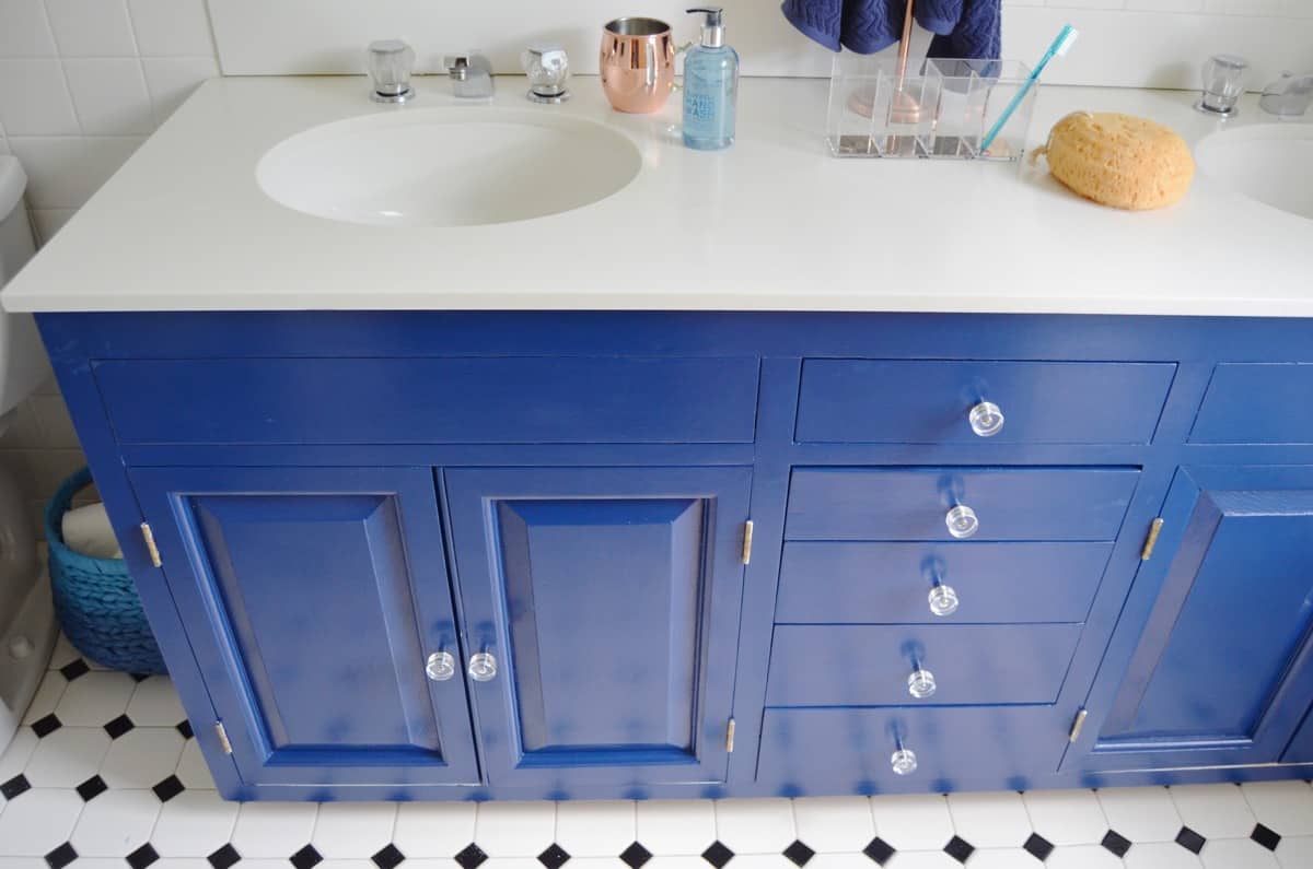 Repainting a basic white vanity with navy blue Satin Enamel paint for an easy bathroom makeover!