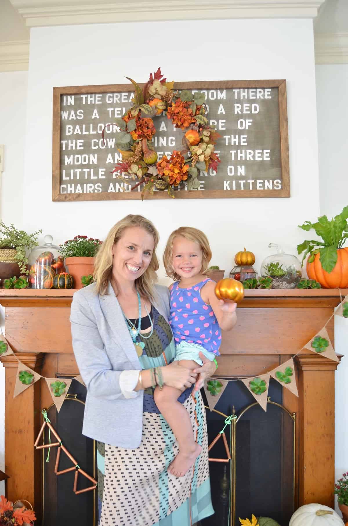 Fall harvest mantel with pumpkins and gourds and succulents.